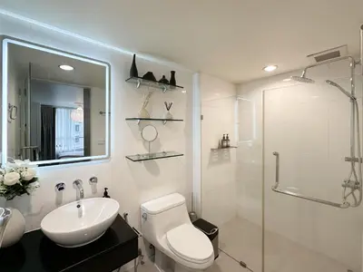 a bathroom with a toilet and a sink and a shower at Prime Classic 1 BR BTS Chidlom 72SQM Langsuan in Bangkok
