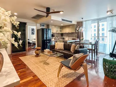 a living room with a couch and a table at Prime Classic 1 BR BTS Chidlom 72SQM Langsuan in Bangkok
