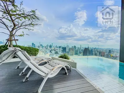 a pair of lounge chairs sitting on a deck next to a swimming pool at \u66b9\u7f57\u767e\u4e3d\u5bab\u5962\u534e\u516c\u5bd3 Siam Paragon Luxury Stay #W08 in Pratunam