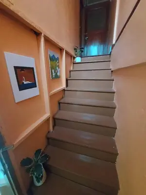 a staircase in a house with a potted plant at best 148 train staytion in Godown