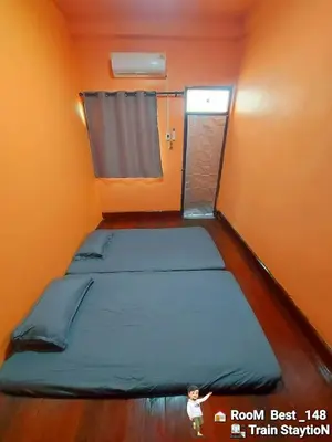 a small room with two beds and a window at best 148 train staytion in Godown