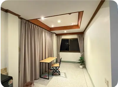 a room with a table and chairs and a window at Omalaya Bangkok in Samphanthawong