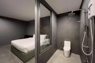 a bedroom with a shower and a bed and a bathroom at HK Villa Resort in Bangkok