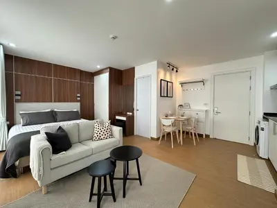 a bedroom with a bed and a couch and a table at 6th Avenue Sukhumvit BKK 403 BTS Asoke Nana MRT Sukhumvit in Bangkok