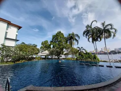 a swimming pool in front of a building with palm trees at Riverview Condo Near Icon Siam Hi Speed Internet in Rat Burana