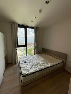 a bedroom with a bed with a large window at Private in Bangkapi in Bangkok