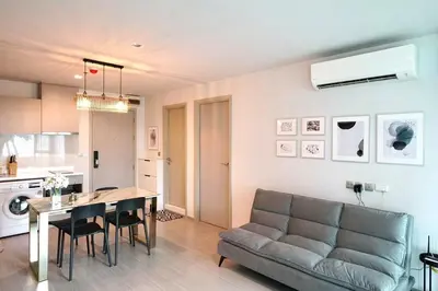 a living room with a couch and a table at 2 Bedroom Life Ladprao in Bangkok