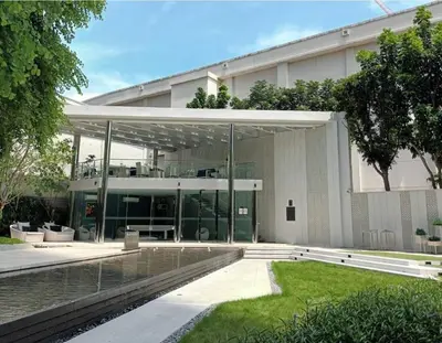 a large building with glass doors and a courtyard at 2 Bedroom Life Ladprao in Bangkok