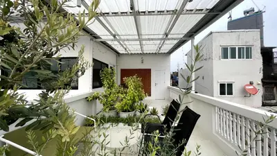 a balcony with potted plants on a building at TermSuk Apt- Banthat Thong in Bangkok