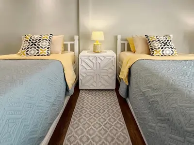 two twin beds sitting next to each other in a room at Urban Charm & Unique at KIT-TI's Art Home Sukhumvit in Bangkok