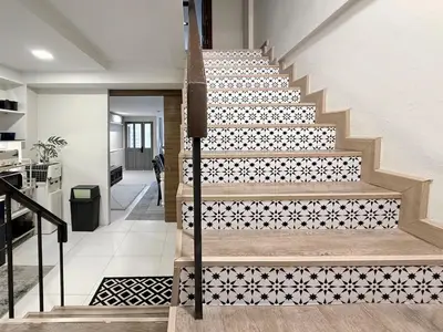 a staircase with a black and white tile pattern at Urban Charm & Unique at KIT-TI's Art Home Sukhumvit in Bangkok