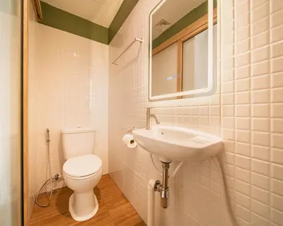 a bathroom with a toilet and a sink at Hotel PaPa Ratchada-Huai Khwang in Bangkok