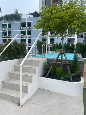 a staircase with a tree in front of a building at Hotel PaPa Ratchada-Huai Khwang in Bangkok