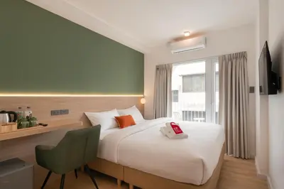 a hotel room with a bed and a window at Hotel PaPa Ratchada-Huai Khwang in Bangkok