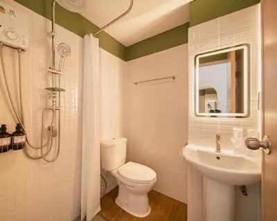 a bathroom with a toilet and a sink at Hotel PaPa Ratchada-Huai Khwang in Bangkok