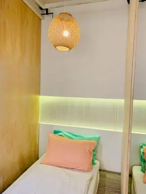 a room with a bed and a pendant light at Loft Rattanakosin Mansion in Bangkok