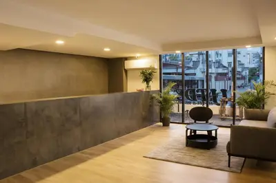 a lobby with a couch and a chair and a table at UTD8 Hotel and Residence in Bangkok