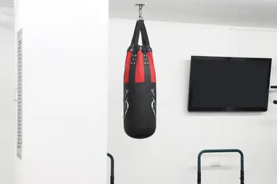 a boxing glove hanging on a wall next to a tv at UTD8 Hotel and Residence in Bangkok
