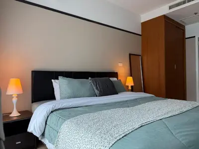 a bedroom with a large bed and two lamps at Noble Remix Thong Lo Long Stay Cozy&Warm Direct access to BTS Pool Gym WiFi in Bangkok
