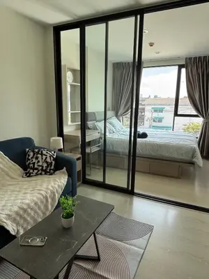 a living room with a bed and a couch at Sukhumvit 50 apartment in Bangkok
