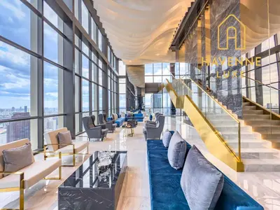 a lobby with chairs and stairs in a building at Luxury Downtown Bangkok 2BR 2BA Sky Pool Gym 5MIN Walk to Siam Paragon in Bangkok