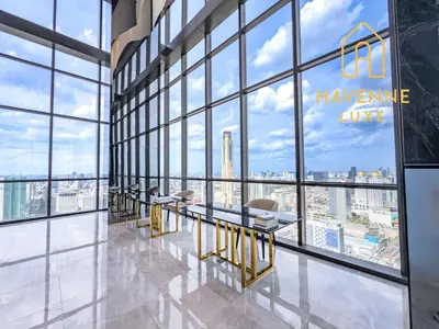 a row of tables in a room with large windows at Luxury Downtown Bangkok 2BR 2BA Sky Pool Gym 5MIN Walk to Siam Paragon in Bangkok