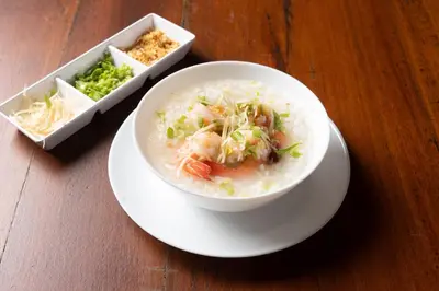 a bowl of soup on a plate on a table at Dewan Bangkok in Bangkok