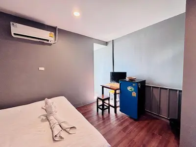 a hotel room with a bed and a air conditioner at Onnut36 Apartment Panasan in Amphoe Phra Khanong