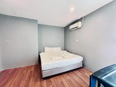 a small room with a bed and a air conditioner at Onnut36 Apartment Panasan in Amphoe Phra Khanong