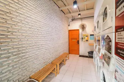 a hallway with a brick wall and a wooden bench at Rose Loft Family or friends 6 person in Thonhuri