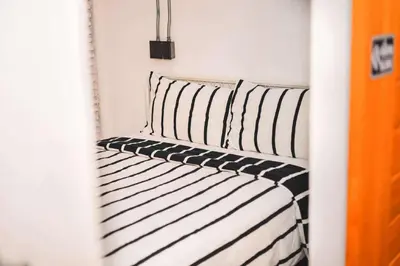 a bedroom with two black and white striped beds at Rose Loft Family or friends 6 person in Thonhuri