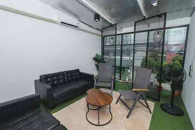 a living room with a couch and a table and chairs at Rose Loft Family or friends 6 person in Thonhuri