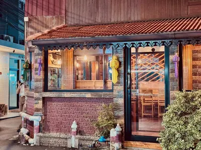 a house with a window with a table in it at Sukhum Ban Songthai in Bangkok