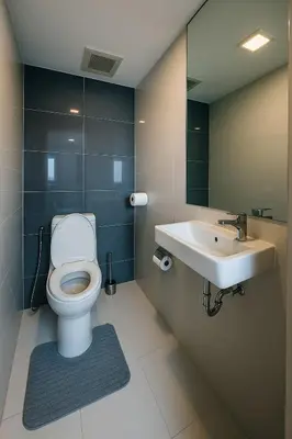 a bathroom with a toilet and a sink at The Monti Condo in Bangkok