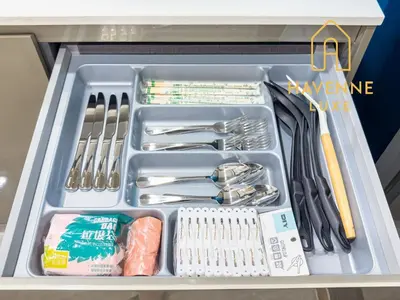 a drawer filled with utensils in a refrigerator at City Luxe Condo 5-Min Walk to Siam Paragon Modern Stay in Bangkok