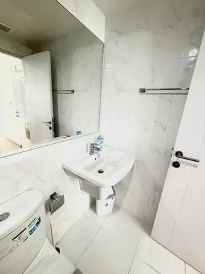 a white bathroom with a sink and a toilet at Bangkok apartment in Bangkok