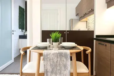 a kitchen with a wooden table with two dishes on it at New Renovated 2 Beds Amazing Balcony View Nana BTS in Bangkok