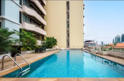 a swimming pool on the roof of a building at Cozy Urban Retreat in Sukhumvit Steps to BTS Nana in Bangkok