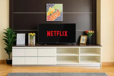 a tv sitting on top of a white entertainment center at The Wooden Nest Warm Stay at Sukhumvit 8 in Bangkok