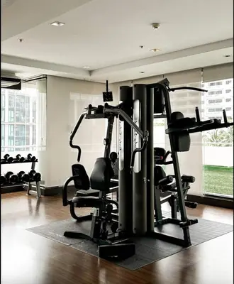 a gym with several treadmills and tread machines at The Wooden Nest Warm Stay at Sukhumvit 8 in Bangkok