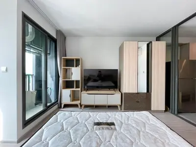 a living room with a bed and a tv at 1 bedroom Life Ladprao in Bangkok