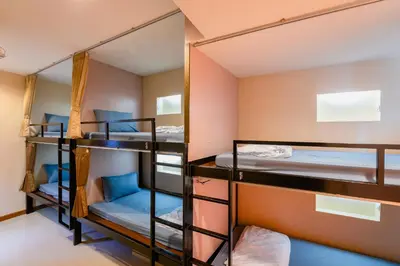 a room with bunk beds in a hostel at Restiny Hostel in Bangkok
