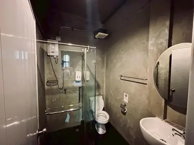 a bathroom with a shower and a toilet and a sink at Sukhum Victorymonument-Ari in Bangkok