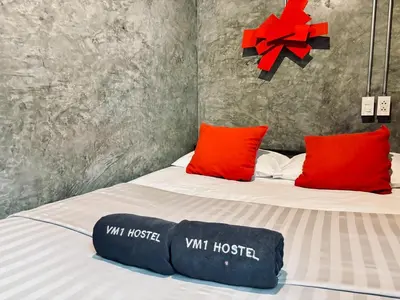 a bedroom with a bed with red and black pillows at Sukhum Victorymonument-Ari in Bangkok