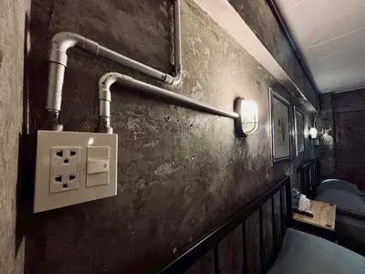 a bathroom with pipes on the side of a wall at Sukhum Victorymonument-Ari in Bangkok