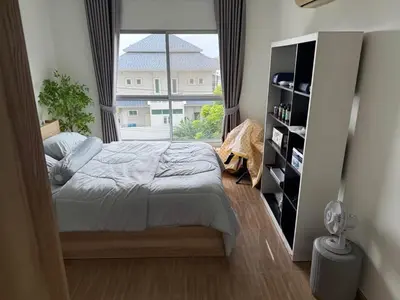 a bedroom with a bed and a large window at 1 bd at s&s sukhumbit in Amphoe Phra Khanong