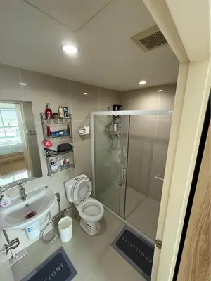 a bathroom with a shower and a toilet and a sink at 1 bd at s&s sukhumbit in Amphoe Phra Khanong