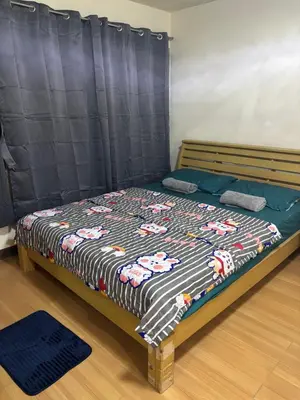a bedroom with a bed with a blanket on it at Ally home 14 06 in Thung Si Kan