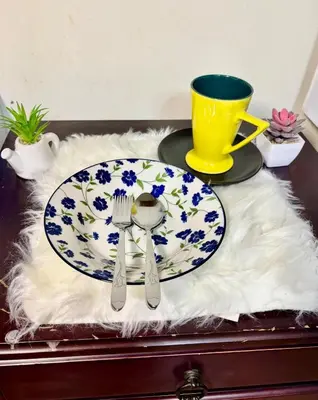 a table with a plate with a spoon and fork at Ally home 14 06 in Thung Si Kan