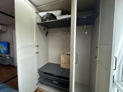 a closet with white doors and shelves in a room at Cozy Room - On Nut - Wi-Fi, Gym, Pool in Bangkok